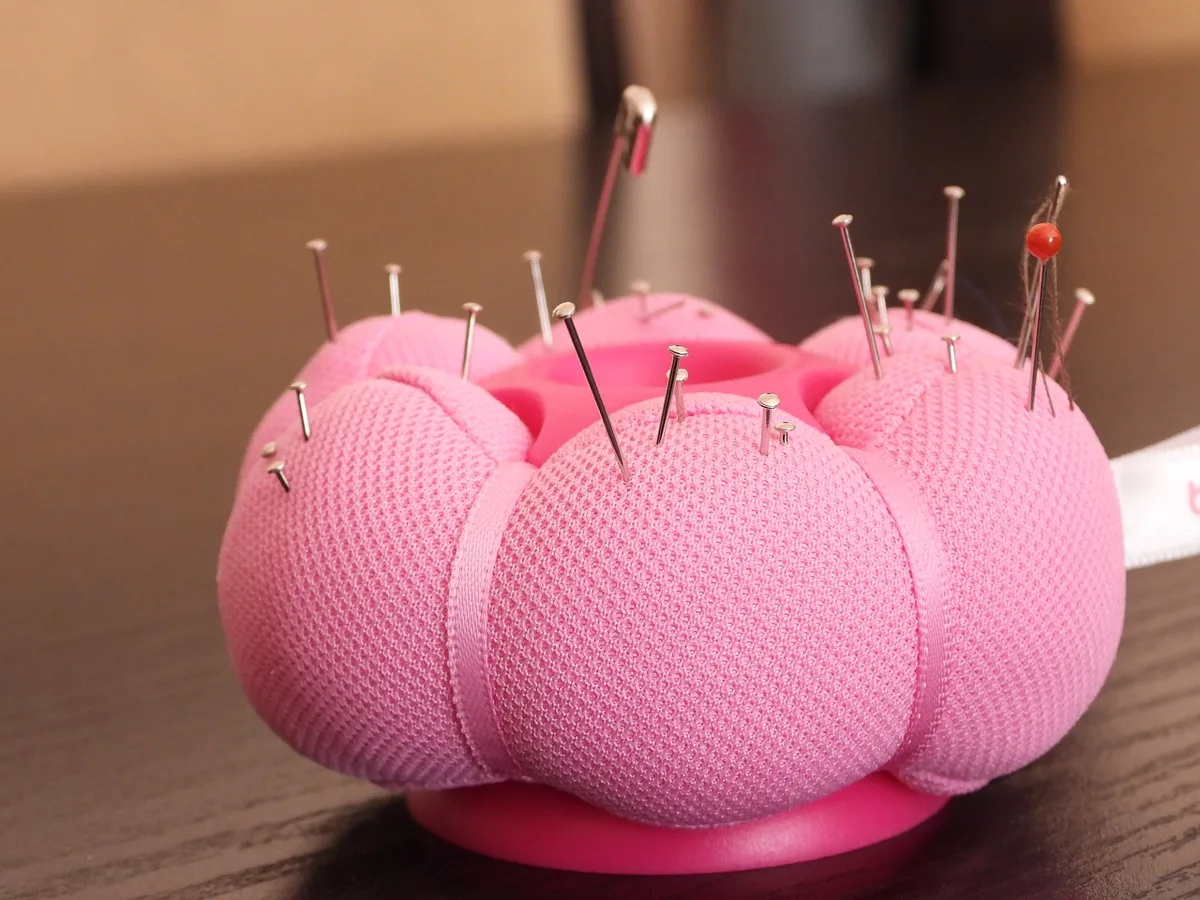 A seamstress’s pin cushion with pins and needles